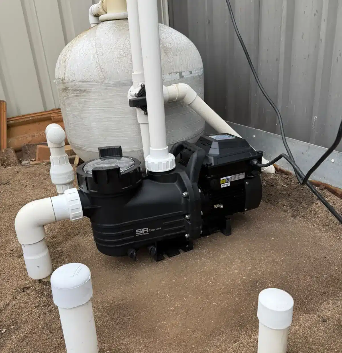 New variable speed pool pump installed beside a sand filter